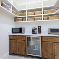 Custom pantry with wood cabinets and open shelving